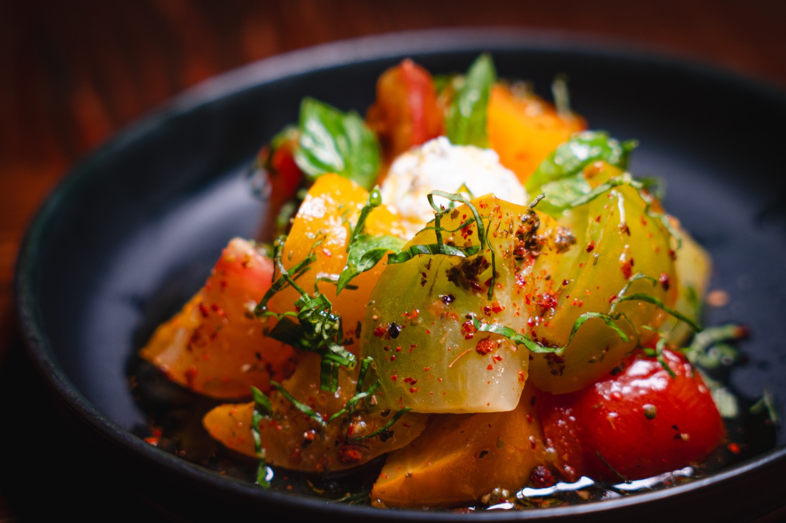 Heirloom tomatoes from Blue Moon Acres with whipped feta, aleppo pepper and basil oil at WEST10WEST