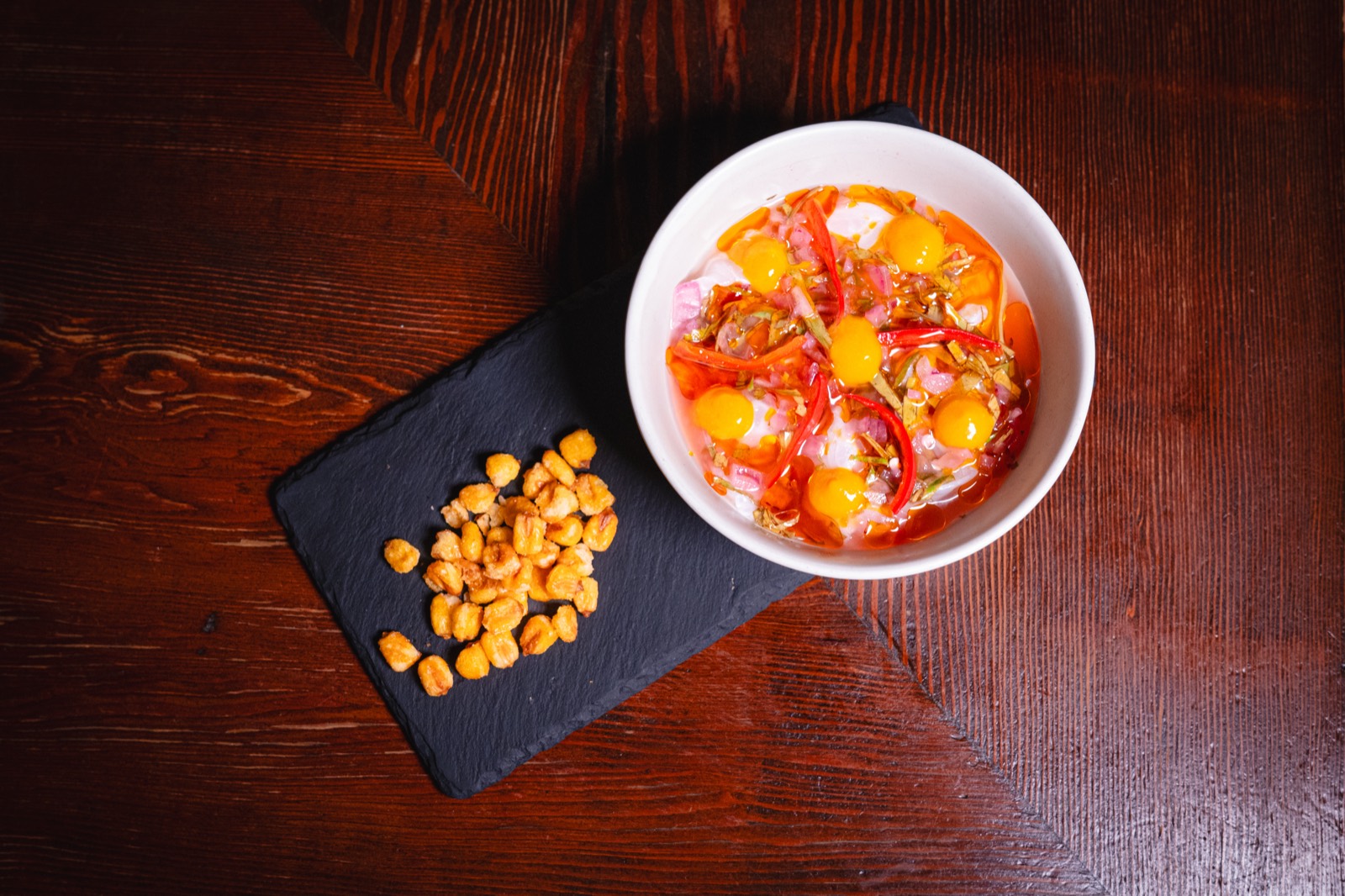 Black sea bass ceviche with aji amarillo, pickled fresno chili and red onion, served with cancha corn at WEST10WEST