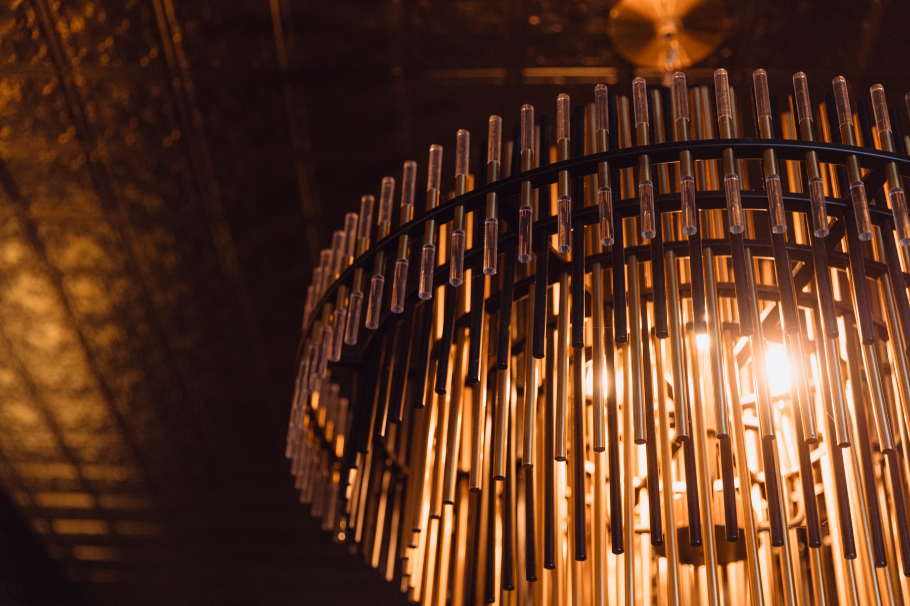 The sculptural brass chandelier over the bar at WEST10WEST