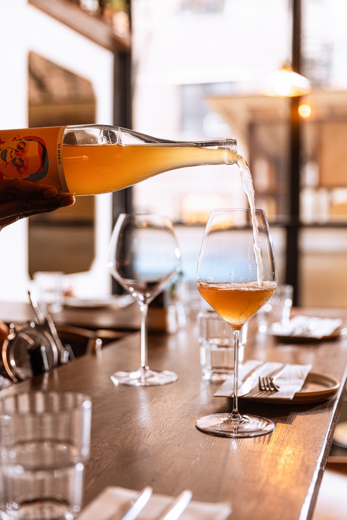 A natural wine being poured at the bar